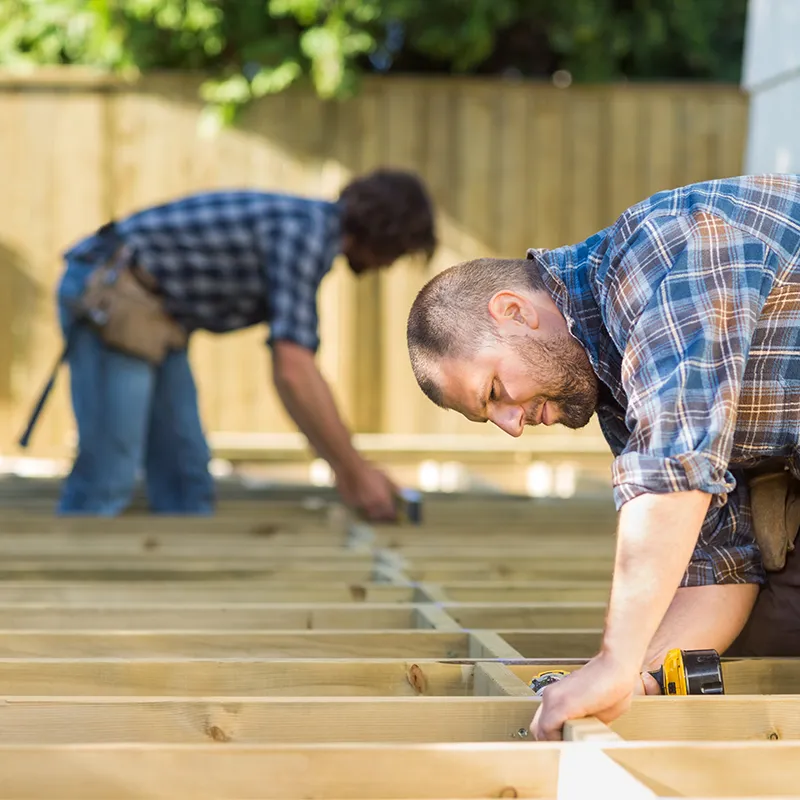 Exterior-Remodeling 2 Workers Building a New Deck Outside | In and Out Flooring