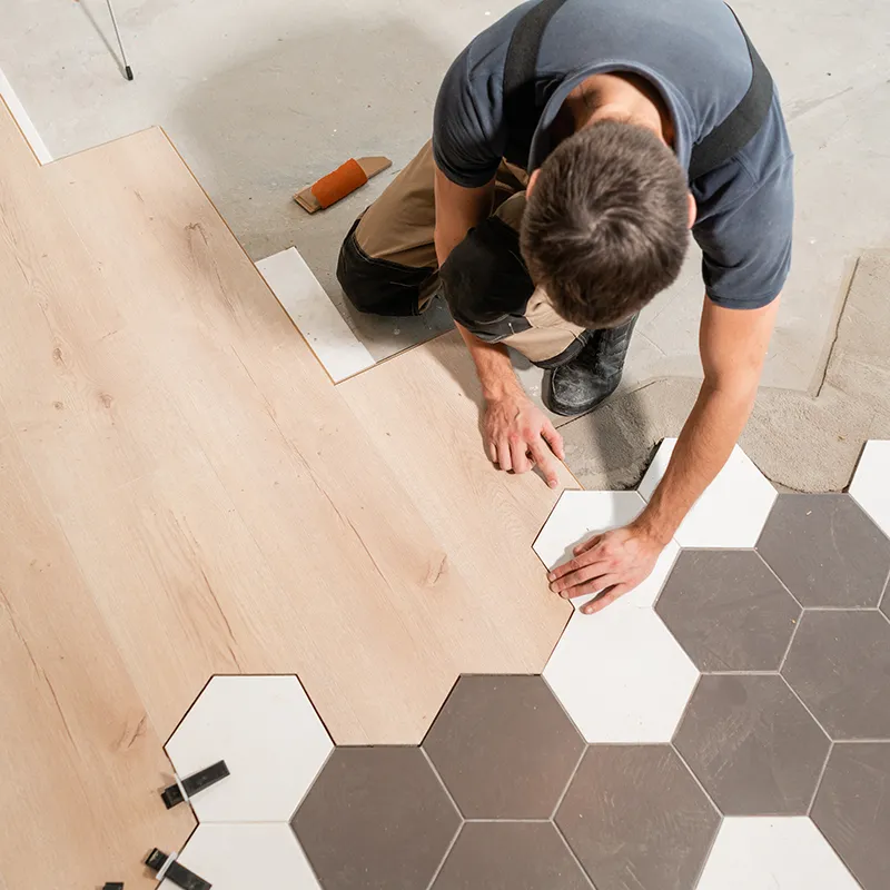 Floor-Installation Worker installing hardwood and tile | In and Out Flooring