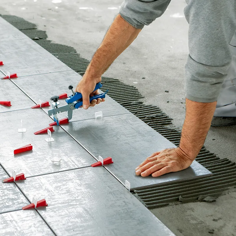 Floor-Remodeling Worker installing tile | In and Out Flooring